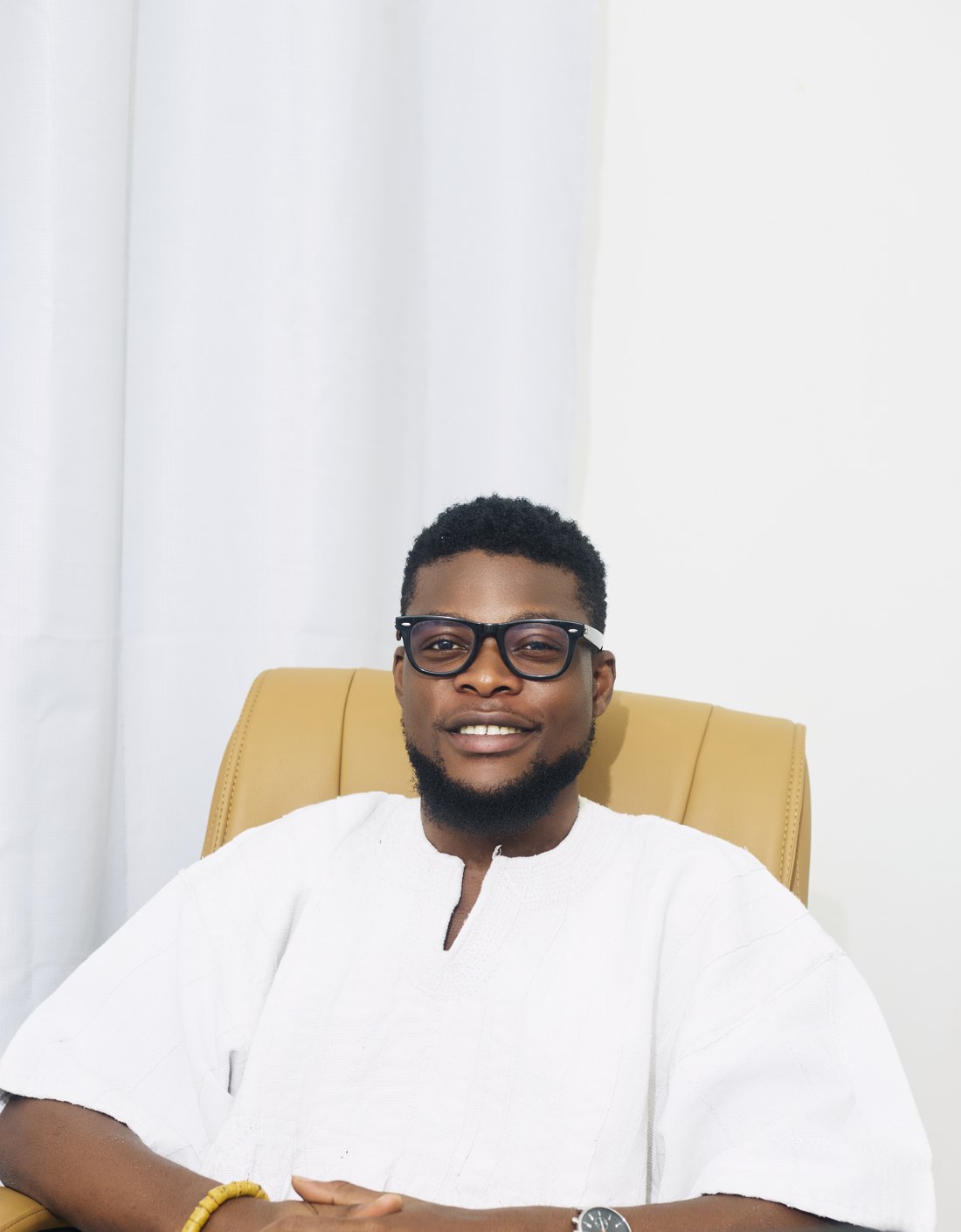 The founder of Gh Pro Fugu, wearing a hand-woven white smock